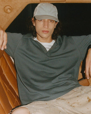 Man wearing a grey cap and grey polo shirt, styled look from the Gifts for Him collection